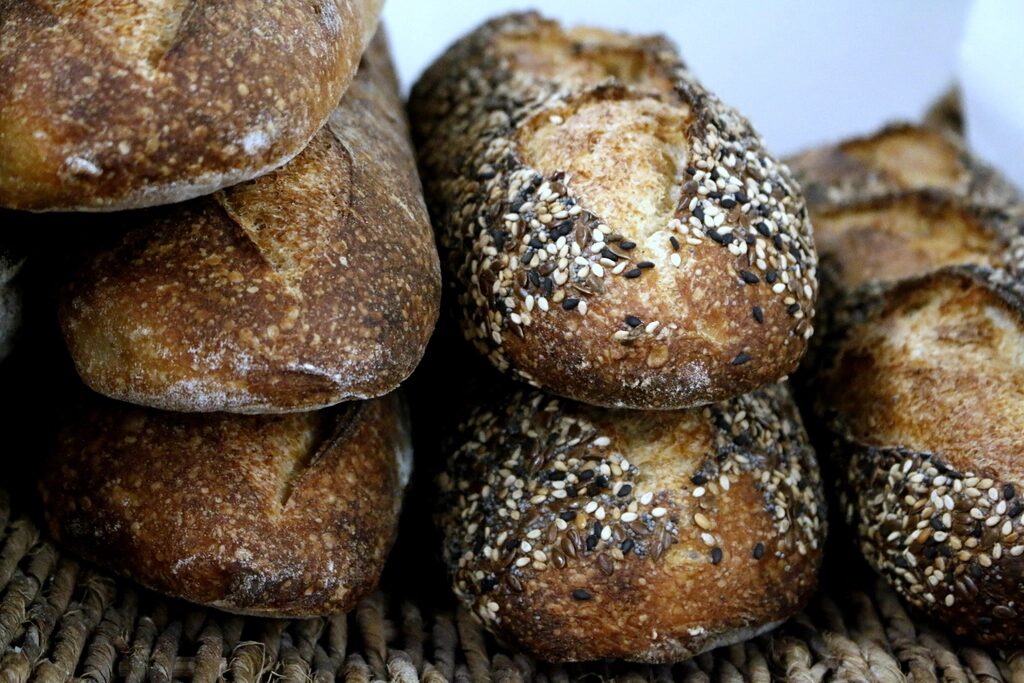 Seeded sourdough loaves stacked in a basket