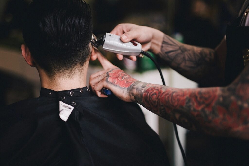 Barber shaping a fade with clippers