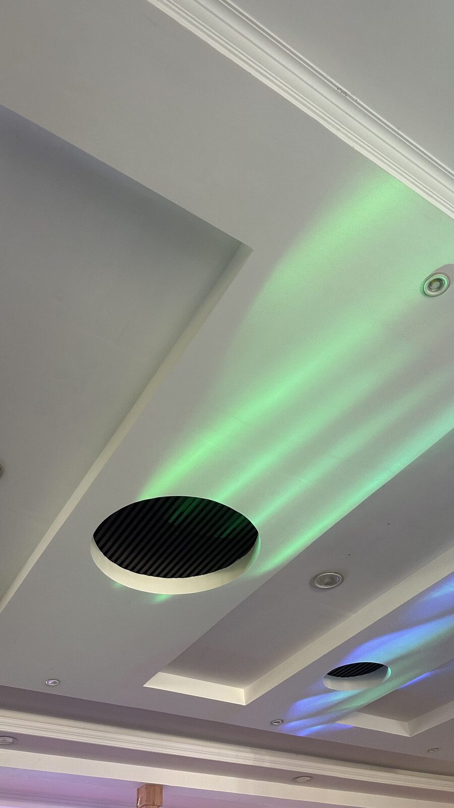 A round ceiling air vent in a bright room