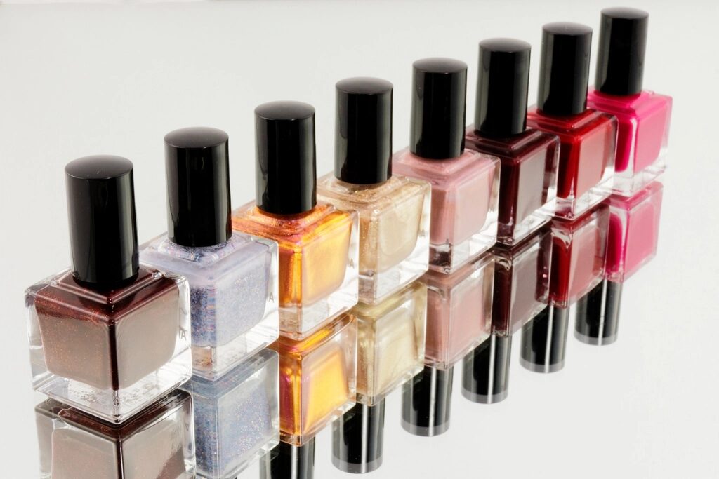 Row of polish bottles from brown to bright pink